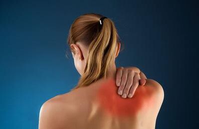 Back pain in the shoulder blades of a woman